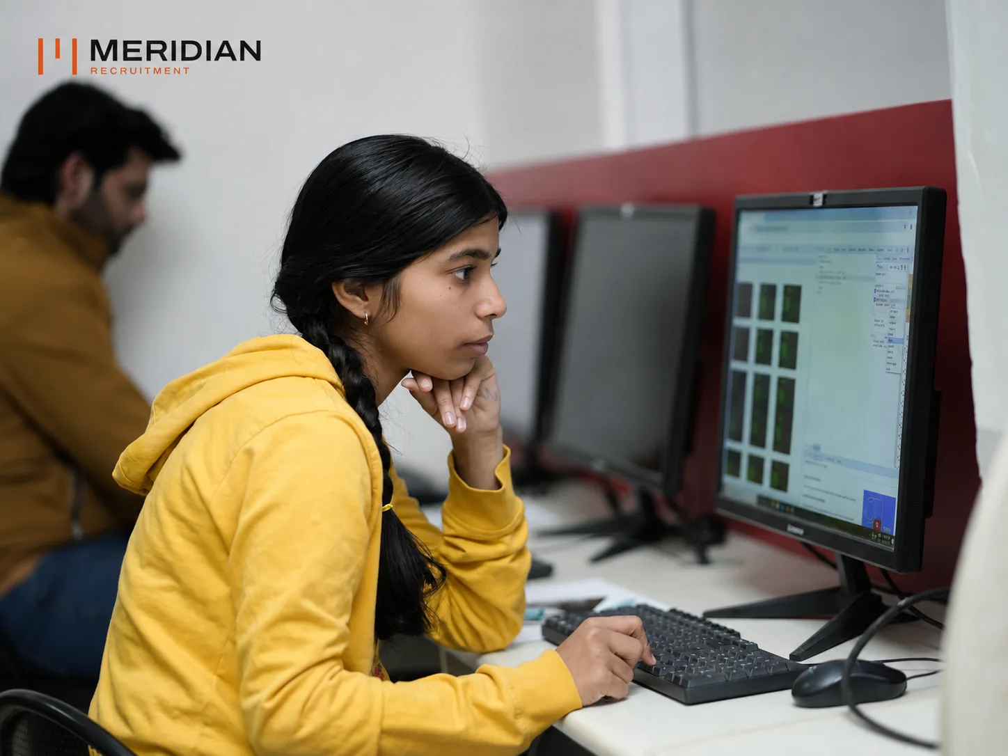 Developer concentrating on code at a workstation